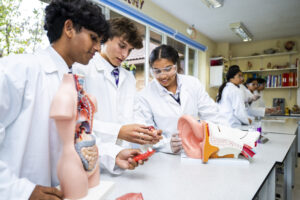 Senior students in science lab wearing laboratory coats