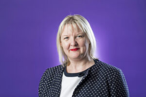 Headmistress headshot purple background