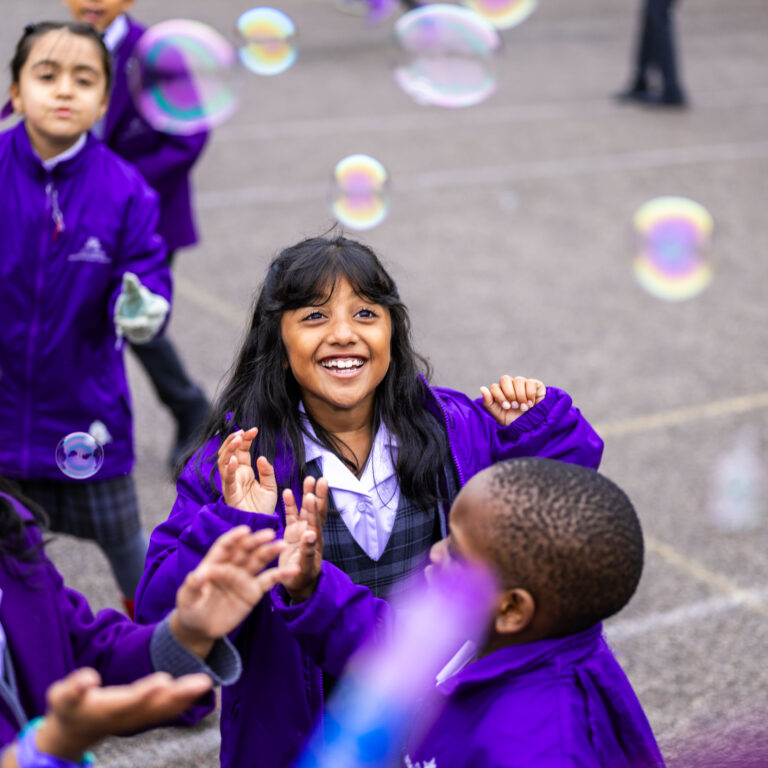 Students in the playground with bubbles