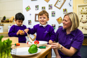real food role play with nursery leader and nursey boy smiling